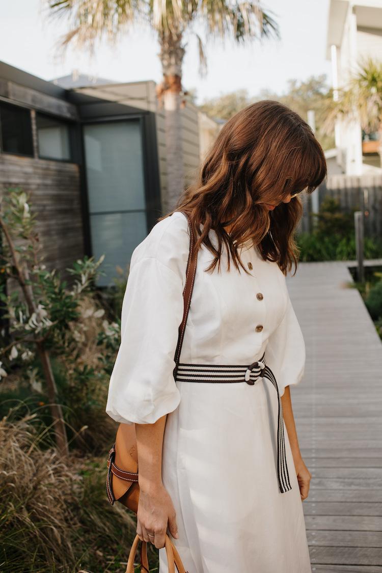 Sigourney wears Elka Collective dress, sunglasses by Chloe, bag by Loewe, bag by Louis Vuitton