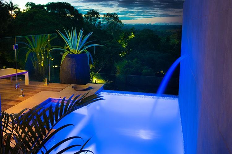 The villa pool glows blue at night