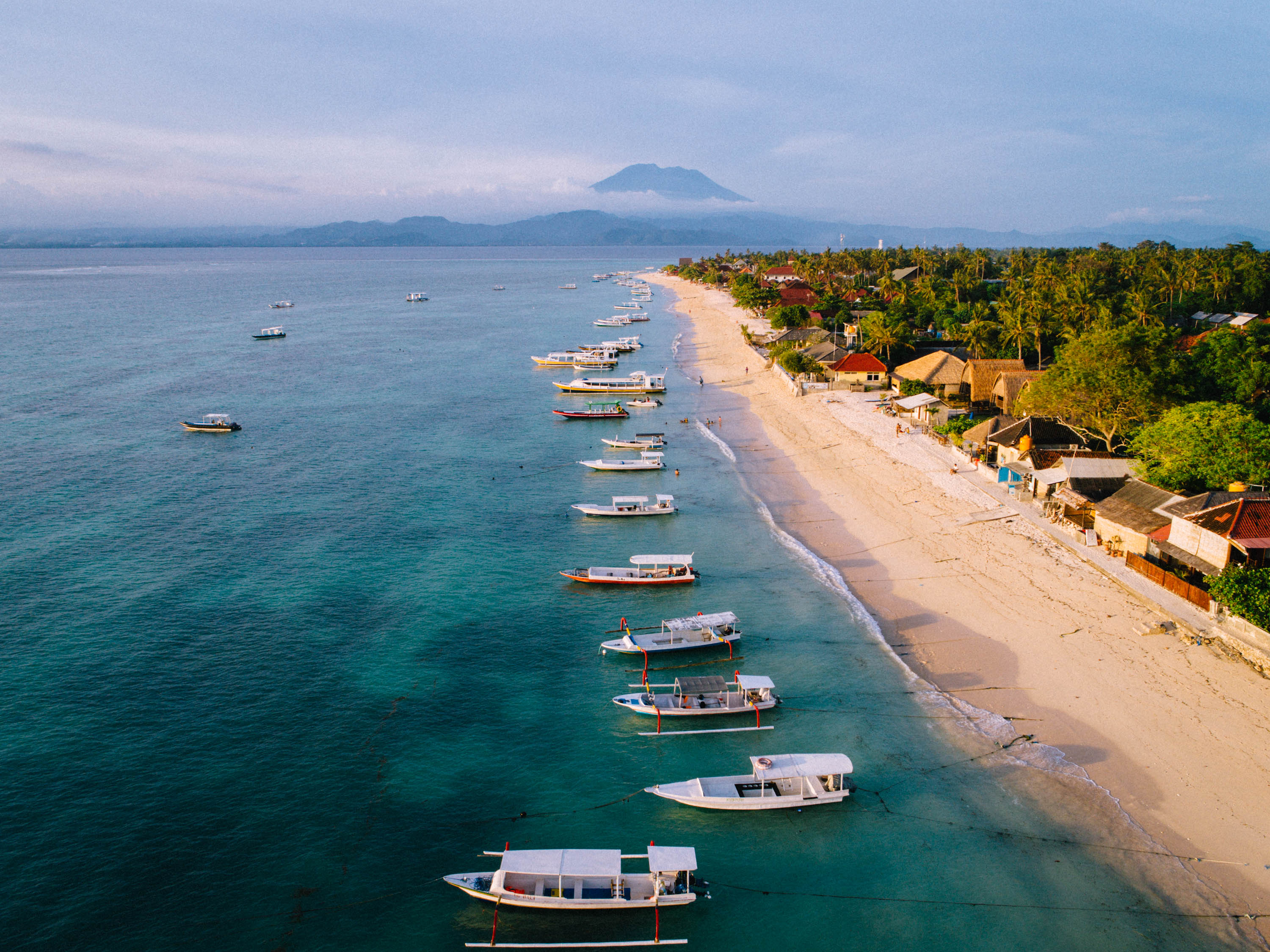 The Jungut Batu waterfront — Bar Riva's patch of the island, with white rattan and a sea view