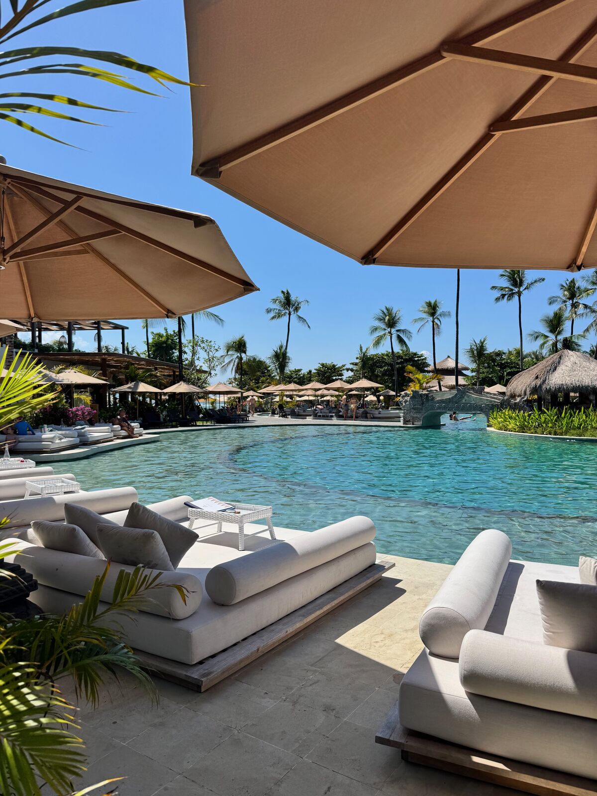 Main pool area at Paradisus by Meliá Bali with white loungers