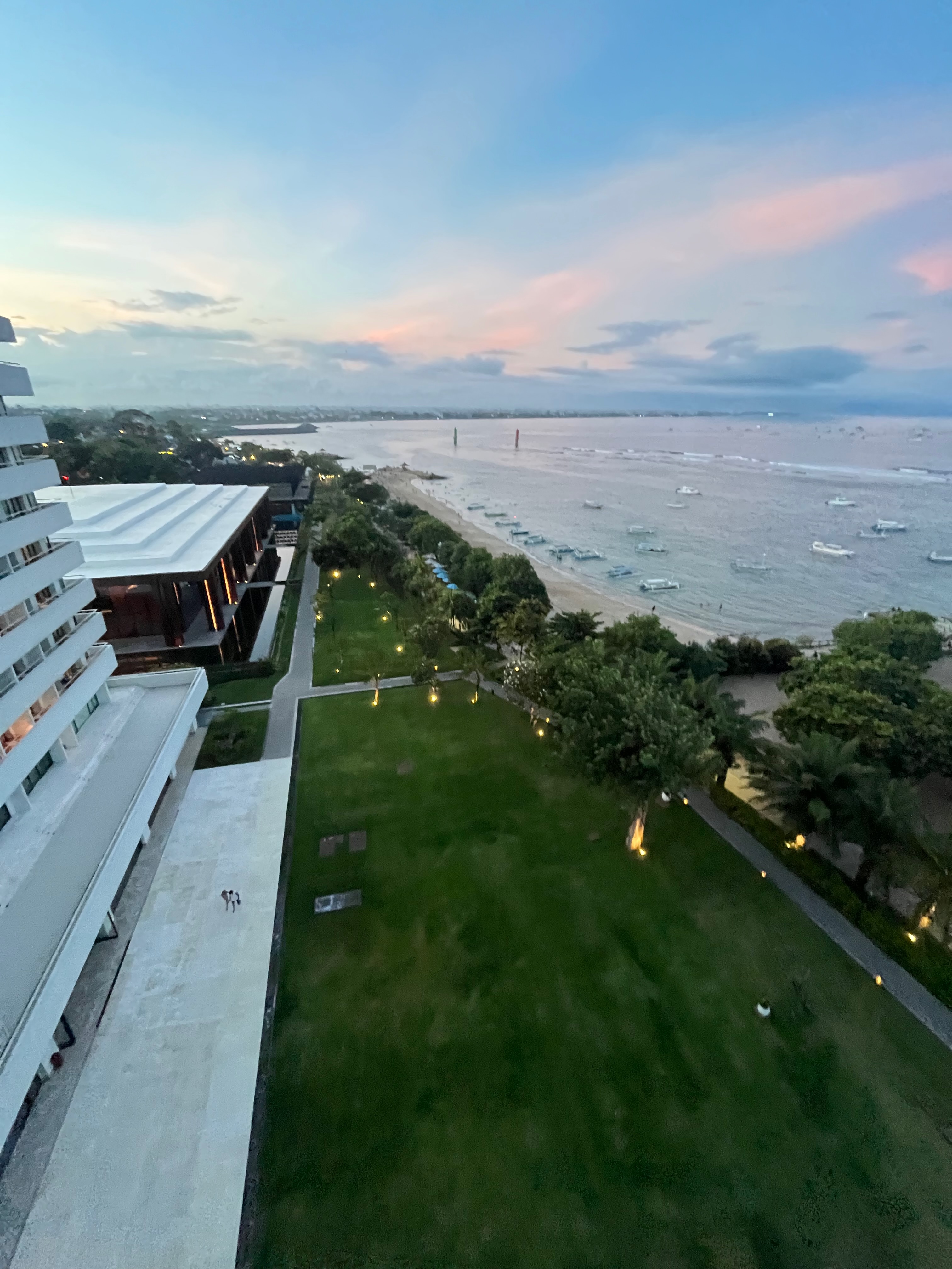 Sweeping panoramic view from Bali Beach Hotel over the Sanur coastline, tropical gardens and the Bali Sea