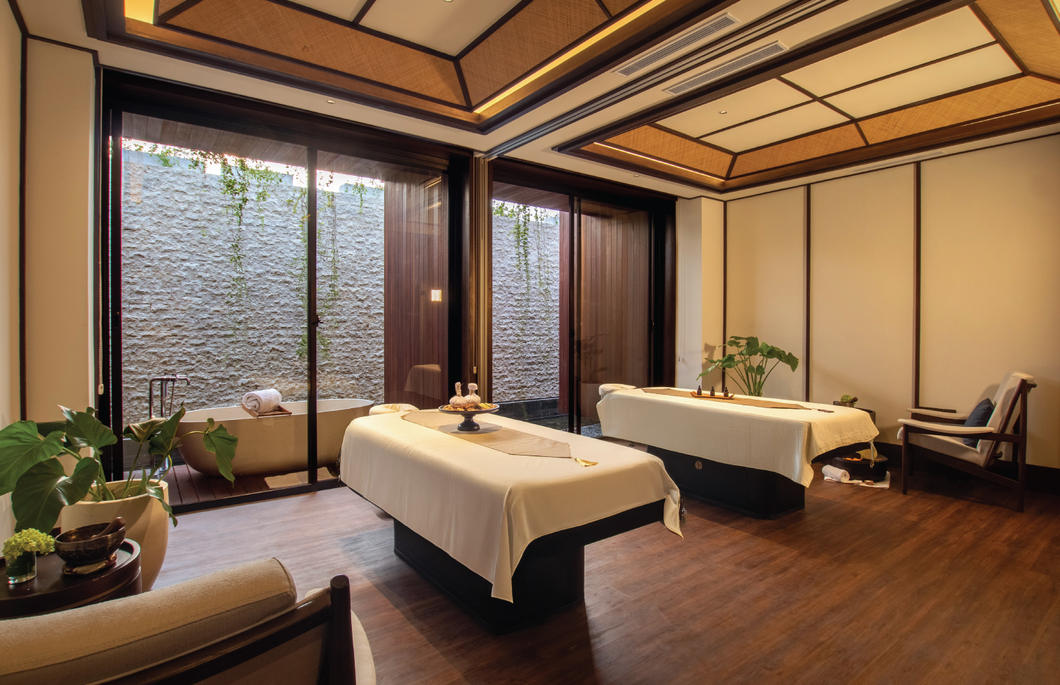 A private treatment room at Svasana Spa with its own balcony, garden view bath and minimalist timber design