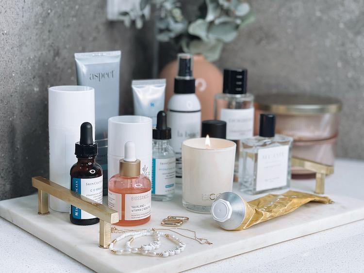Amelia's skincare collection on a marble tray including SkinCeuticals CE Ferulic, Biossance and Ecoya candle