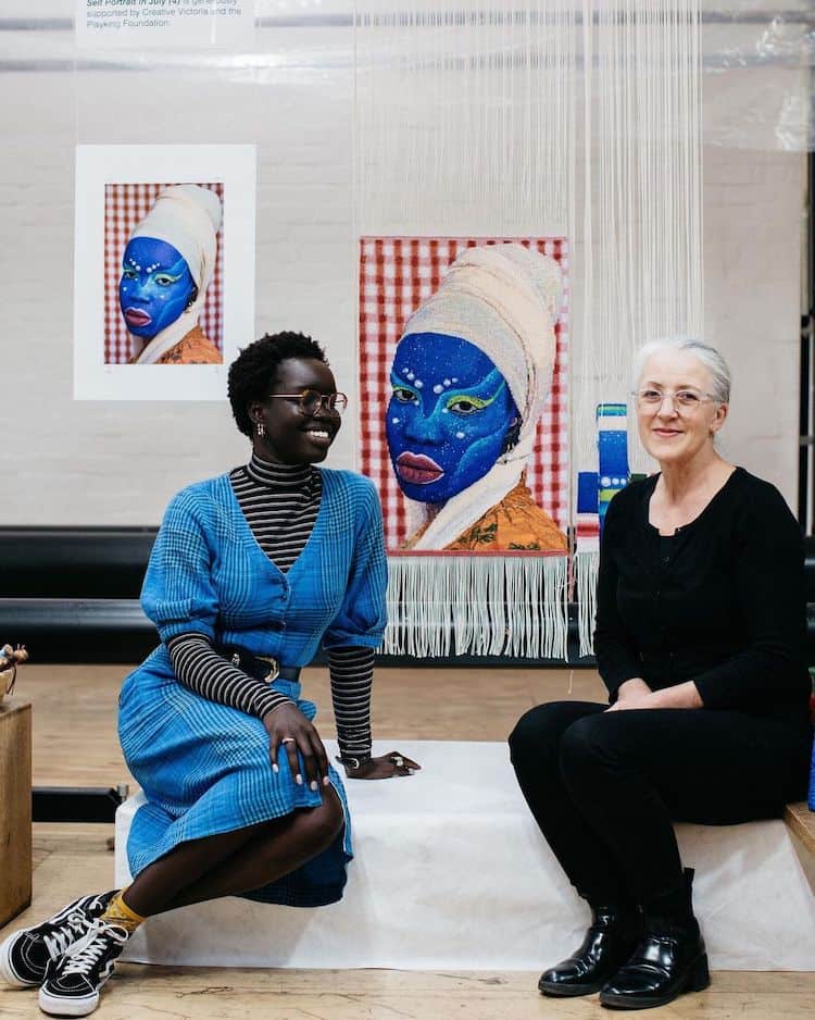 With weaver Pamela Joyce, who turned one of Atong’s pieces into the tapestry hanging behind them as part of an Australian Tapestry Workshop initiative. IMAGE: INSTAGRAM @ATONGATEM