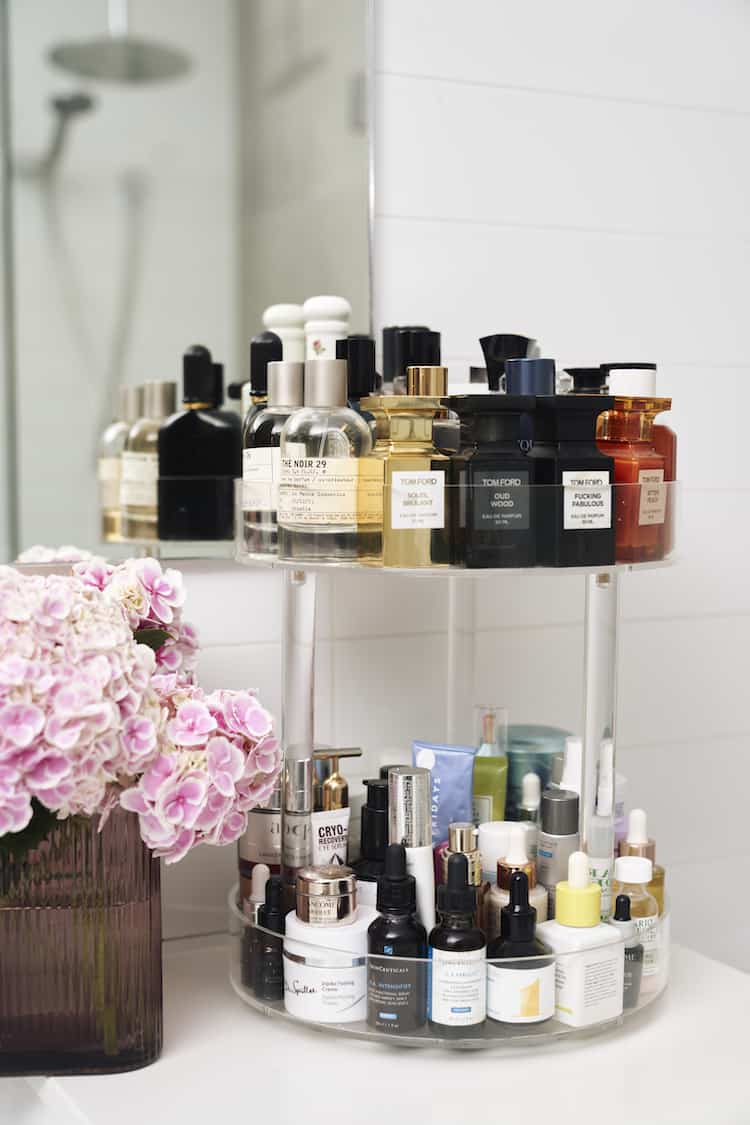 Skincare collection on a rotating tray featuring SkinCeuticals, Dr Spiller and Lancome beside pink hydrangeas