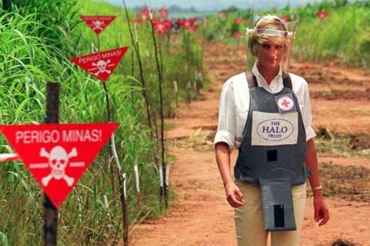 Princess Diana walking through a landmine field in Bosnia wearing protective equipment