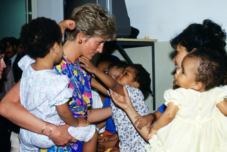 Princess Diana comforting a young patient in a hospital