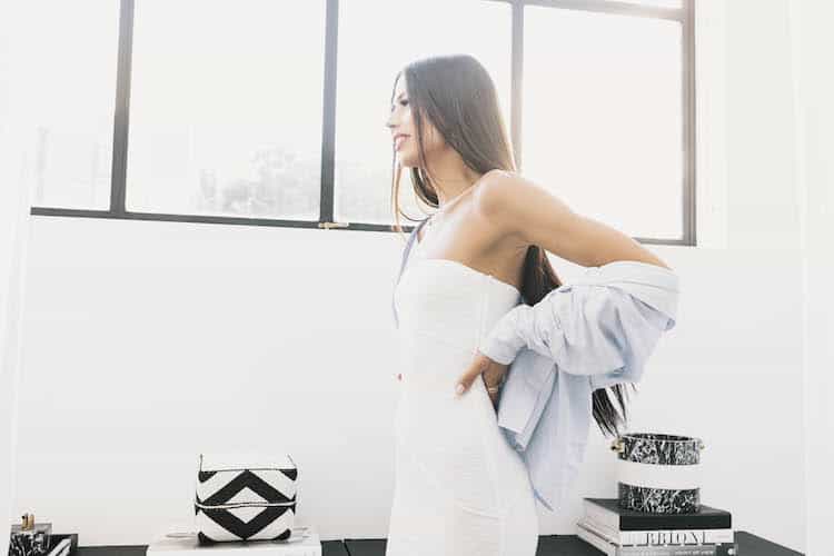 Riley Minford in white strapless dress, bright studio light