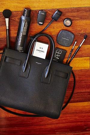 Devin Brugman beauty essentials in Saint Laurent bag