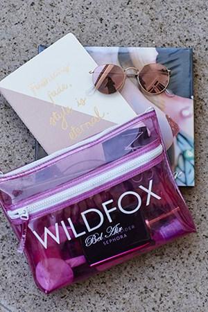 Natasha Oakley and Devin Brugman sharing makeup books and sunnies