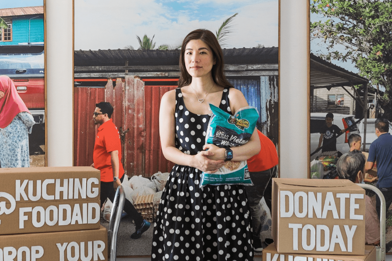 Shentel Lee holding rice at a Kuching Food Aid donation drive, Sarawak Malaysia