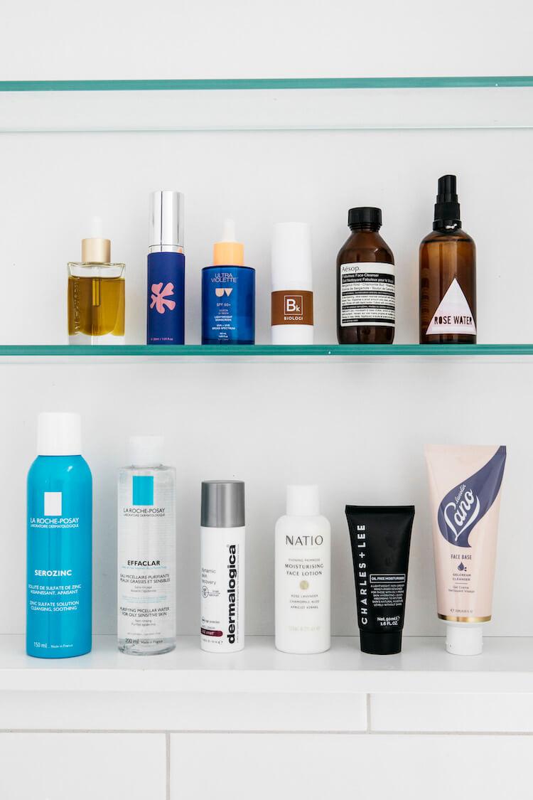 Bathroom glass shelves lined with skincare from La Roche-Posay, Aesop, Biologi, Dermalogica and Lanolips