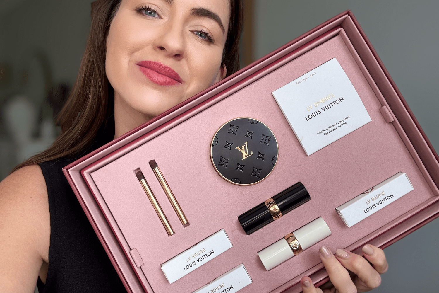 Beauty editor holds the new Louis Vuitton makeup set - including the Louis Vuitton lipsticks and eyeshadow.