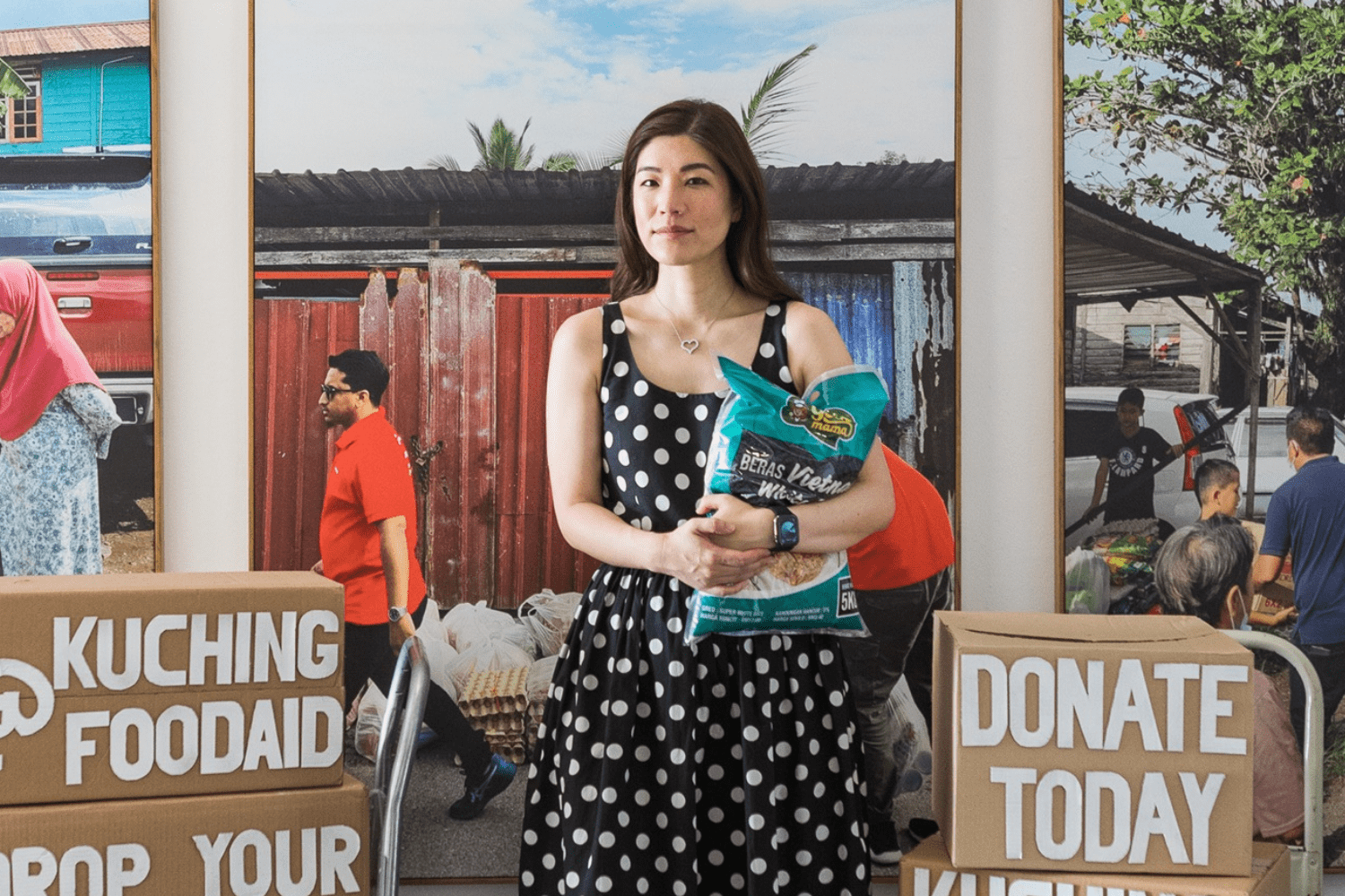 Shentel Lee holding rice at a Kuching Food Aid donation drive, Sarawak Malaysia