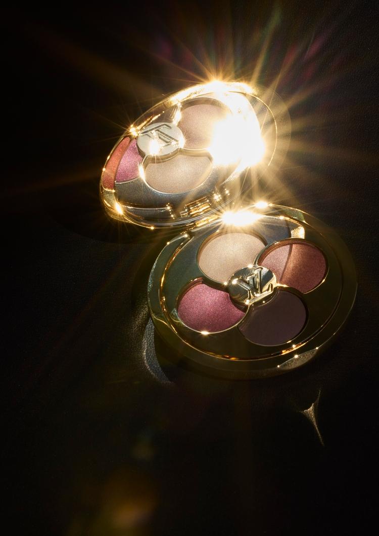 LV Ombres eyeshadow palette displayed against a dark background, with the packaging glistening gold.