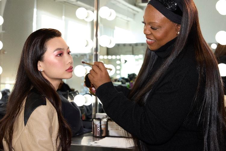 Pat McGrath applying Louis Vuitton makeup on an asian model