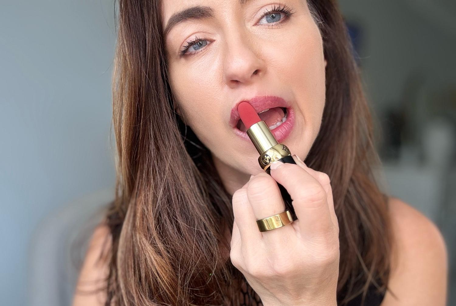 A brunette tries on the Louis Vuitton Rose Odyssey Lipstick