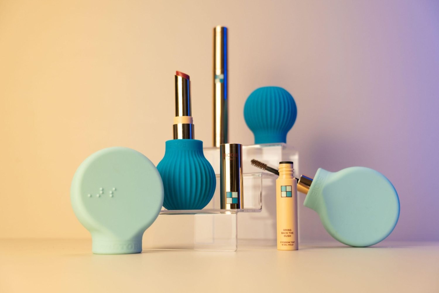 Betty and Margie accessible makeup tools on coloured background — silicone ergonomic beauty applicators