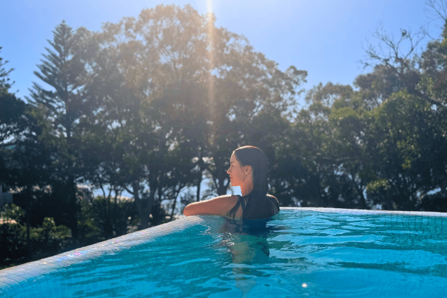 sigourney in pool looking out at view